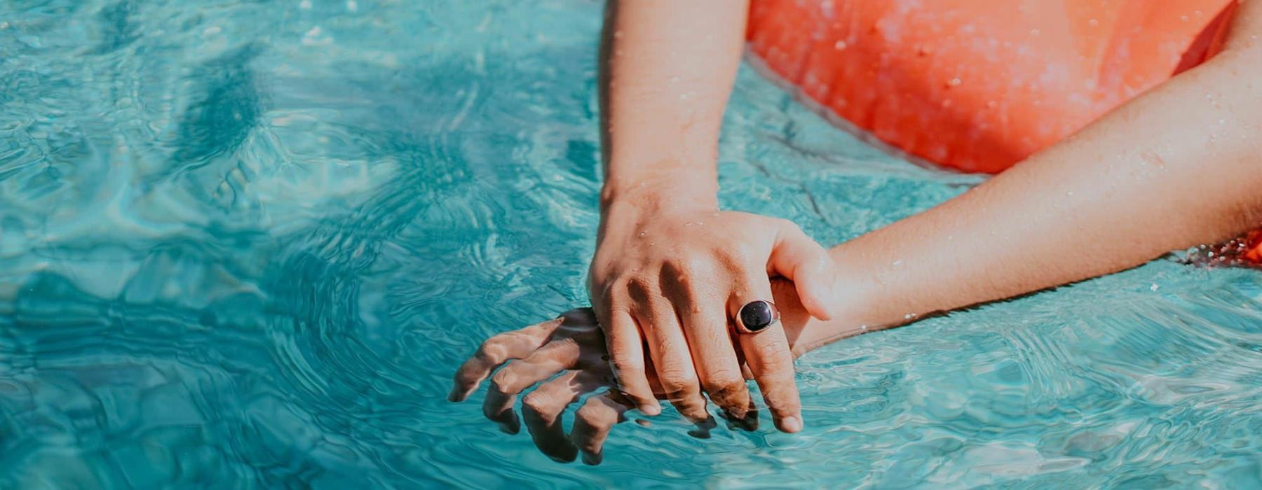 woman relaxes on a floatie in swimming pool