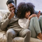 a man and woman sitting on a couch